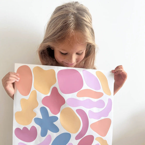 Colorful abstract shapes on white paper.