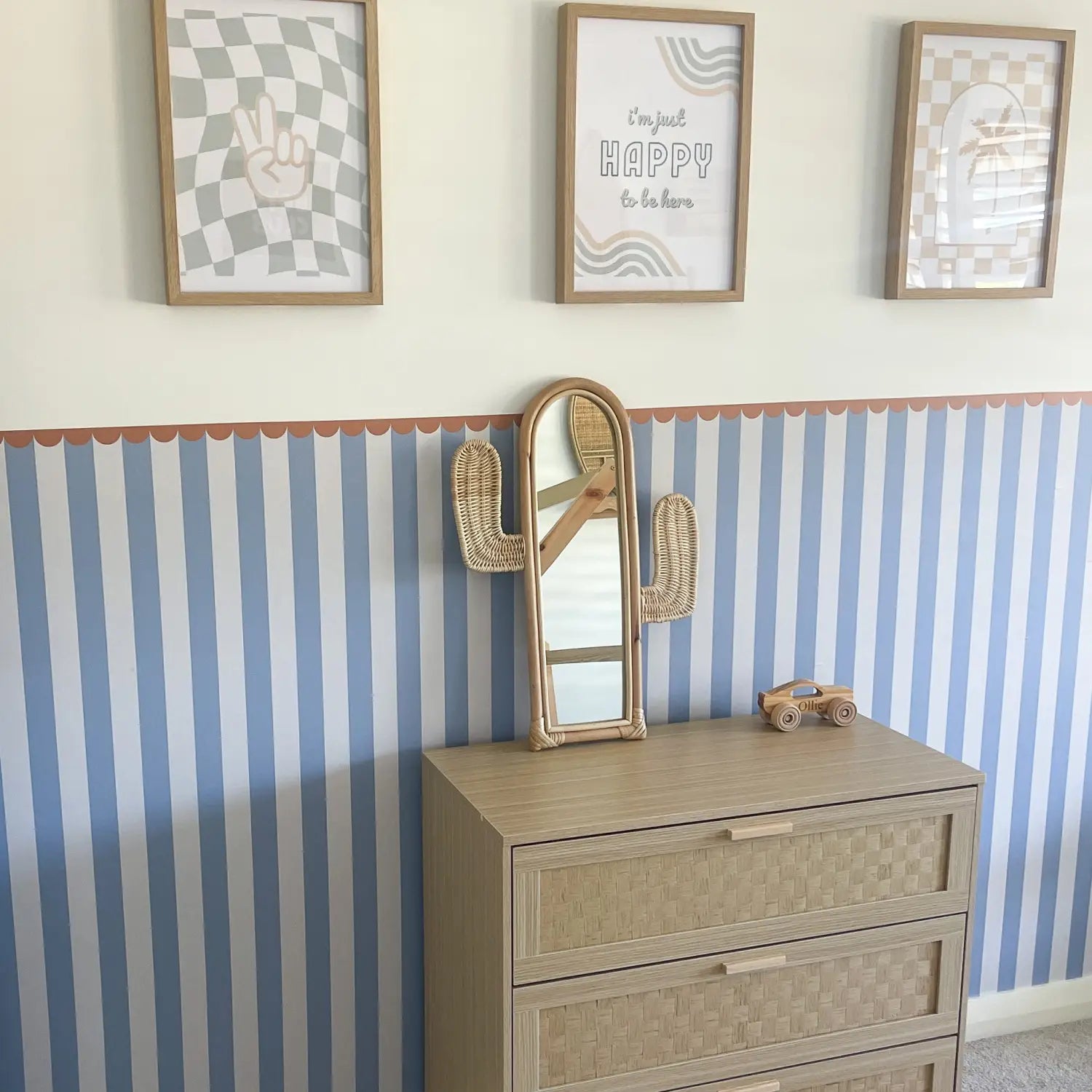 Kids room with blue and white striped wall panel with scalloped trim