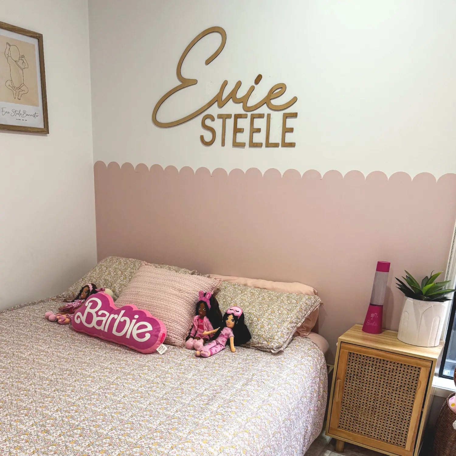 Girls bedroom with pink scalloped wall panel and personalized name decal