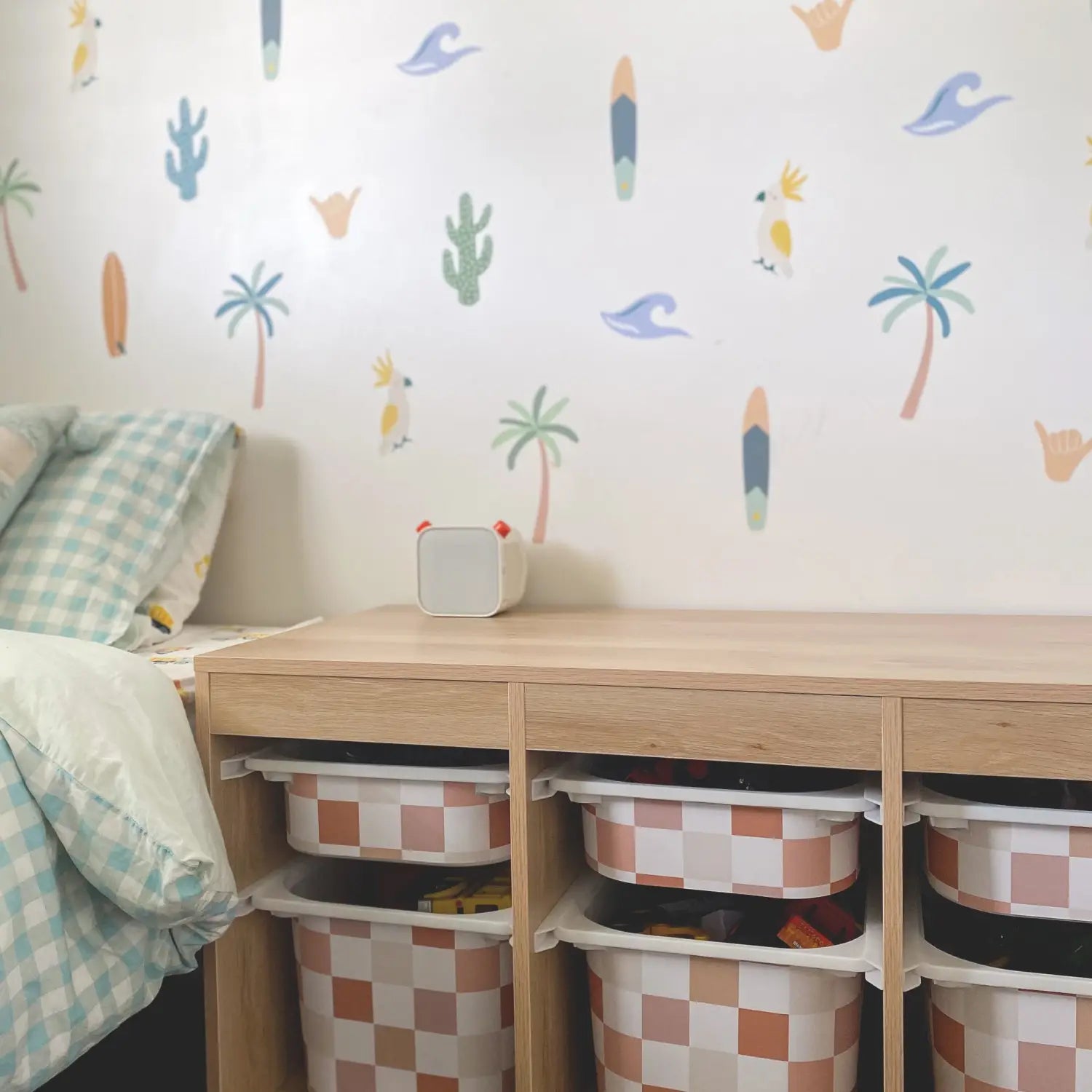 Kids bedroom with fun wallpaper and under-bed storage solutions
