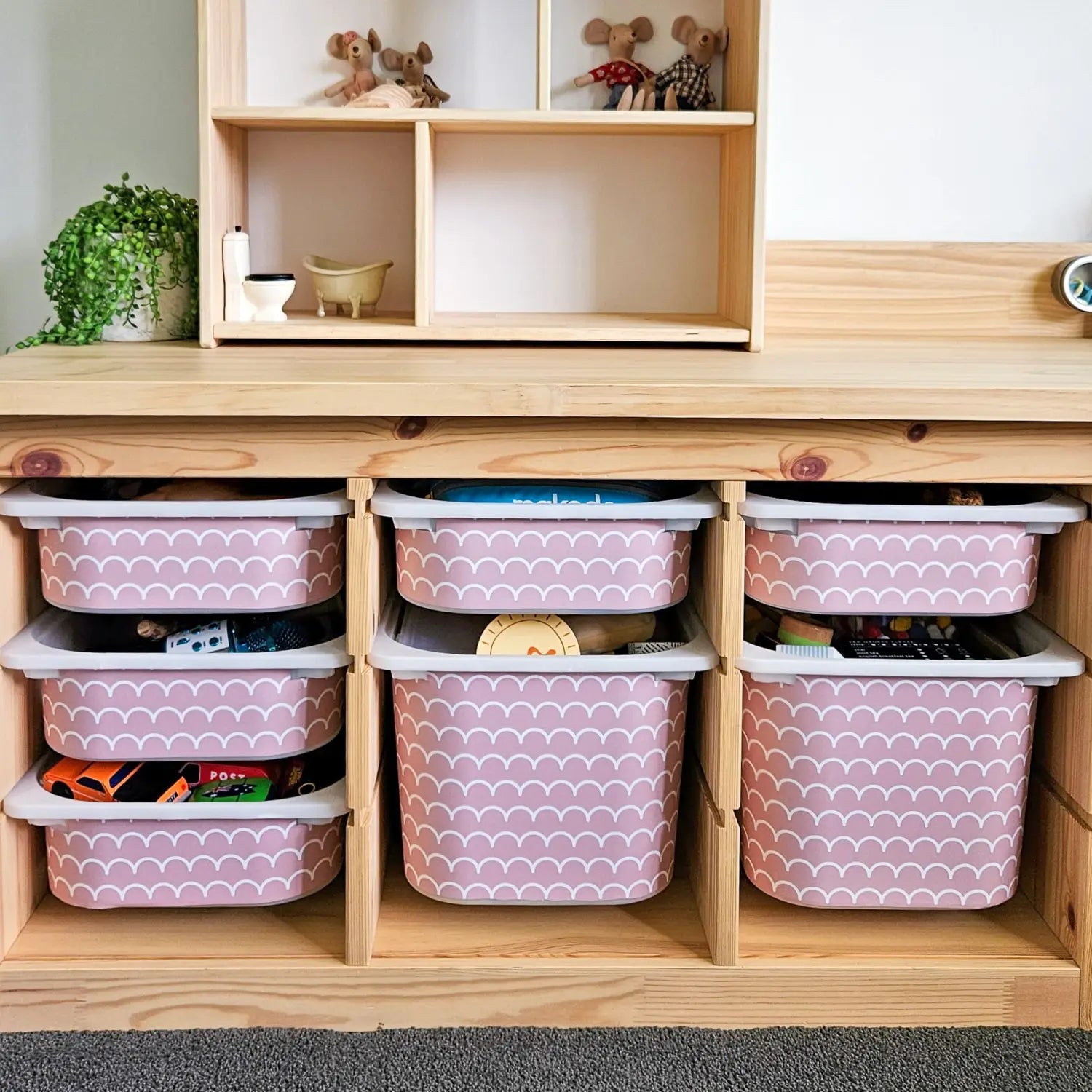 IKEA Trofast storage unit with pink scalloped decals on storage bins