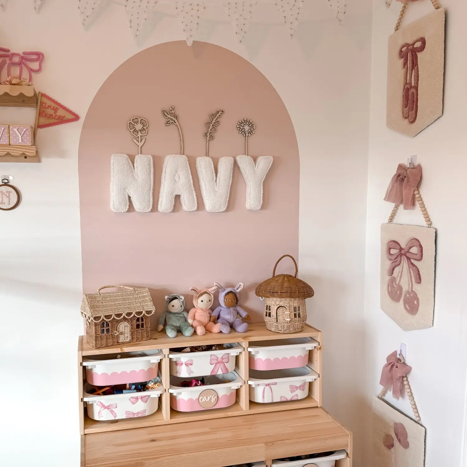 Pink themed kids room with NAVY wall letters and organized toy storage