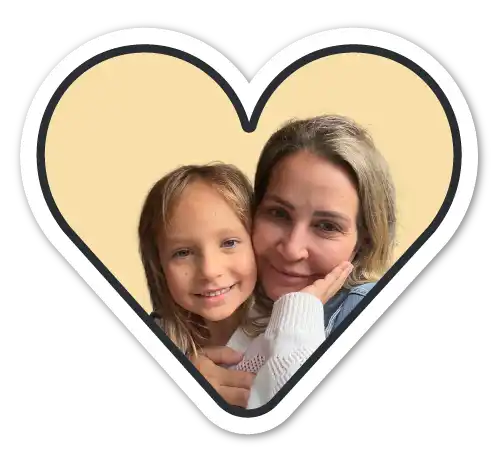Two smiling females in a heart-shaped frame