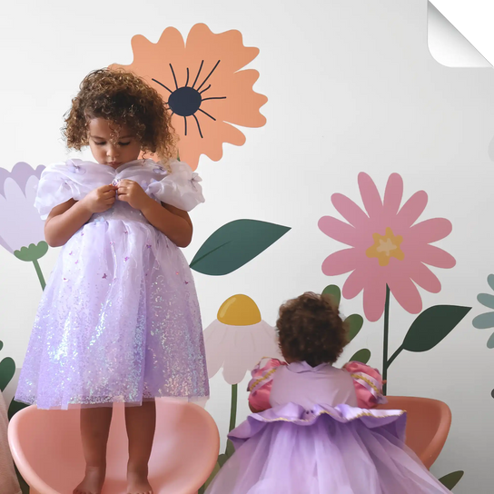 Two young children in lavender party dresses.